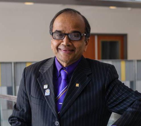 photo of man in suit, wearing glasses